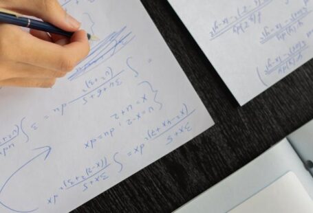 Bachelor's Degrees - Student writing in papers with homework task