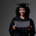 Certifications - Curly-haired graduate student holding certificate