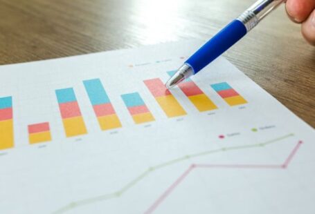 Case Studies - Person Holding Pen Pointing at Graph