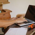 Master's Programs - Crop craftsman working on laptop in workplace
