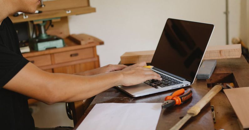 Master's Programs - Crop craftsman working on laptop in workplace