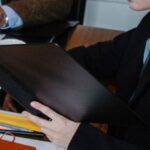 Career Counseling - From above of multiracial lawyer and businessman talking about contract and business papers in office