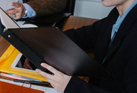 Career Counseling - From above of multiracial lawyer and businessman talking about contract and business papers in office