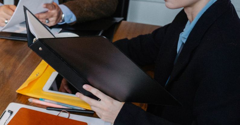 Career Counseling - From above of multiracial lawyer and businessman talking about contract and business papers in office