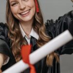 Alumni Networks - Photo of Woman in Academic Dress Holding Diploma