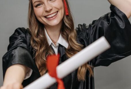 Alumni Networks - Photo of Woman in Academic Dress Holding Diploma