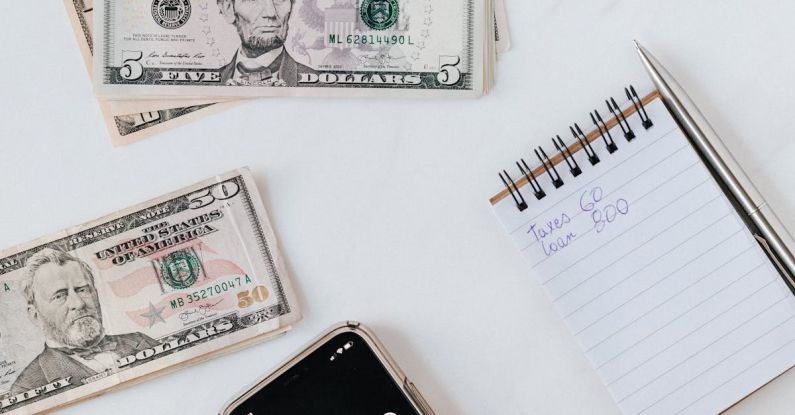 Student Loan Debt - Crop anonymous person calculating profit on smartphone calculator near banknotes