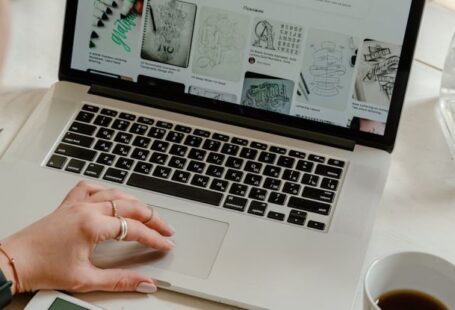 Admission Process - Person Using Macbook Pro on Table