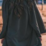 Degrees - Woman in Black Long Sleeve Dress Standing on Brown Concrete Pathway