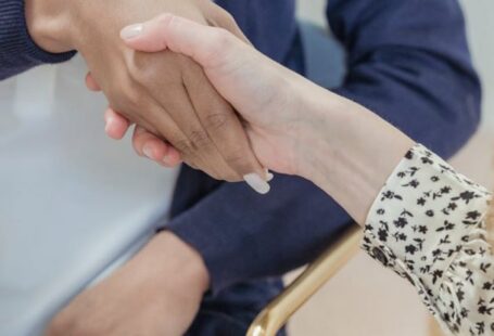 Associate Degrees - Crop anonymous multiracial female coworkers wearing formal clothes shaking hands in modern office