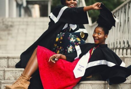 Degrees - Shallow Focus Photography of Two Women in Academic Dress on Flight of Stairs