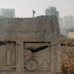 Memory Aids - A stone monument with a city in the background