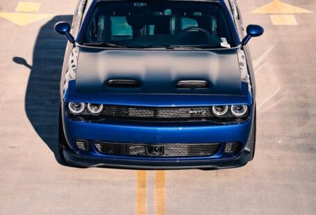 Full-Ride Scholarships - A blue car is parked on the road