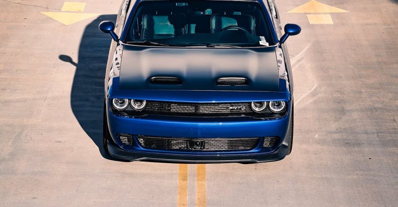 Full-Ride Scholarships - A blue car is parked on the road