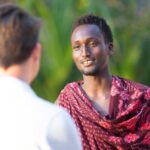 Scholarship Interviews - Men Talking at the Festival