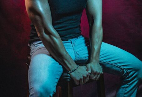 Athletic Scholarships - A man in a baseball cap sitting on a stool