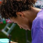 Study Abroad Scholarships - A woman writing on a piece of paper