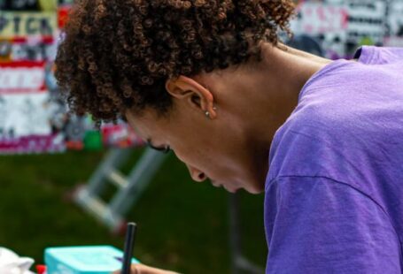 Study Abroad Scholarships - A woman writing on a piece of paper