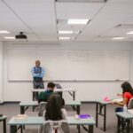 Proctored Examinations - Teacher Proctoring His Students During an Examination